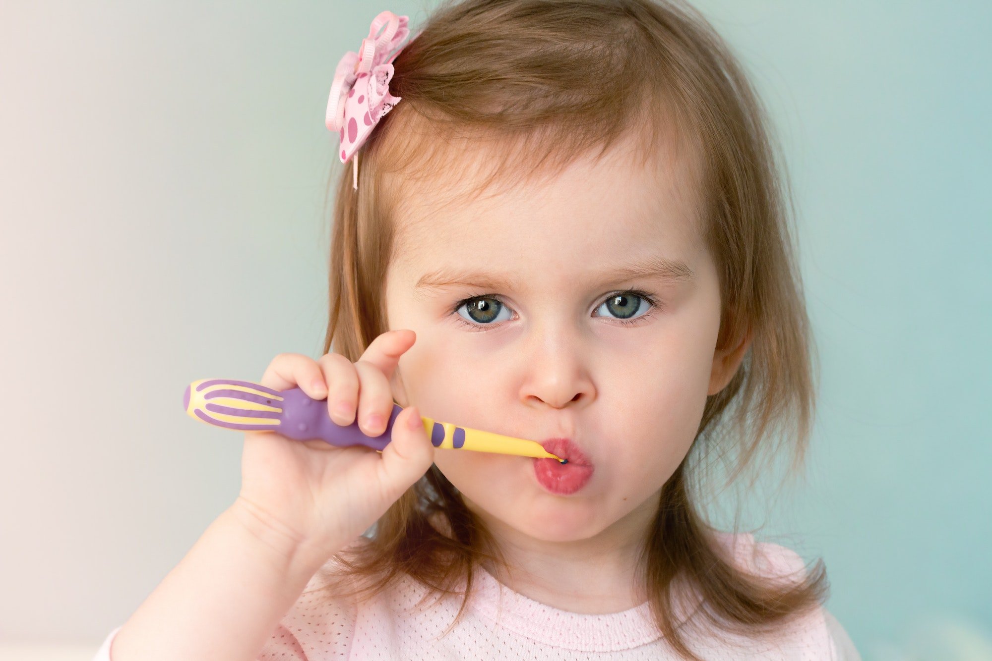 Little girl brushes her teeth