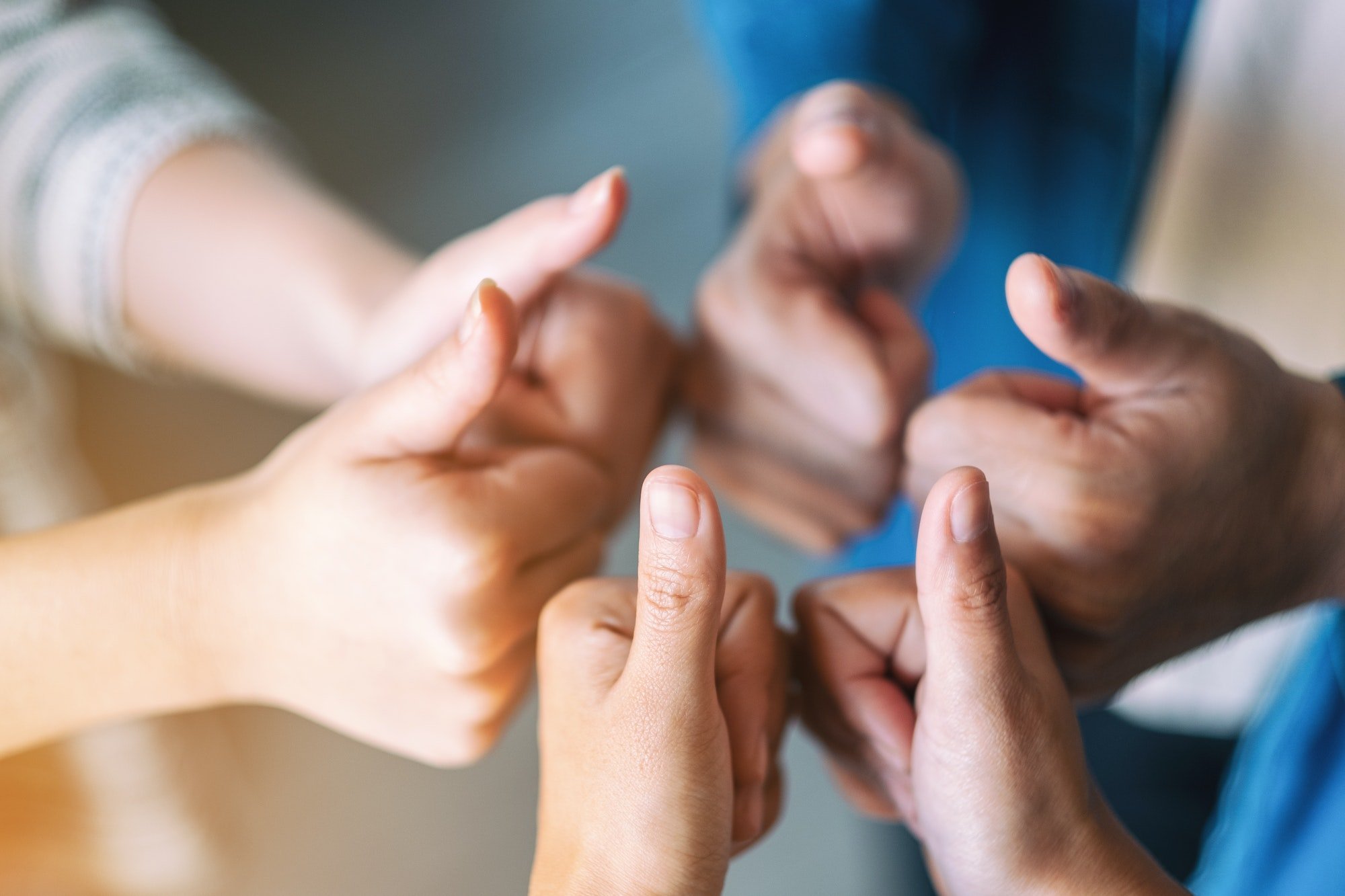 People making thumb up sign in circle